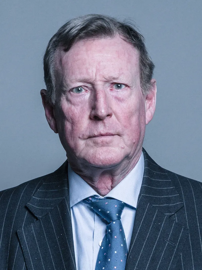 Official portrait photo of David Trimble, a grey-haired man in a pinstripe suit