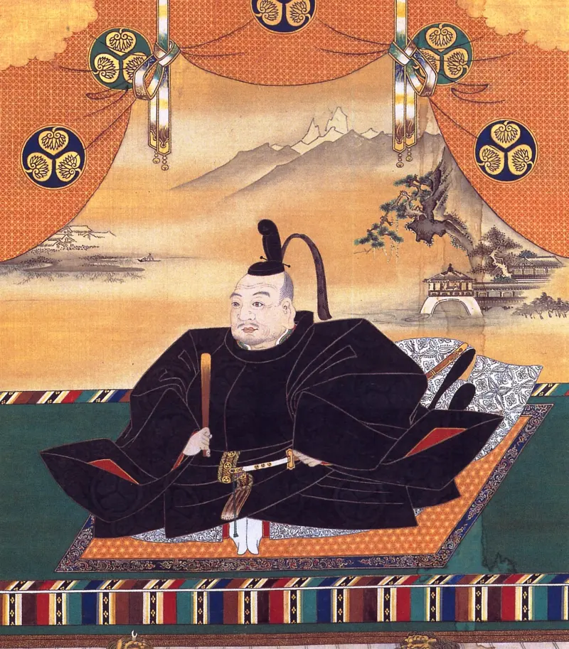 Japanese painting of Tokugawa Ieyasu in black robes sitting on a mat under red curtains